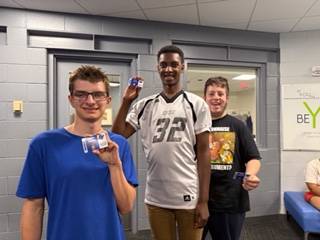 student holding Rec Center cards